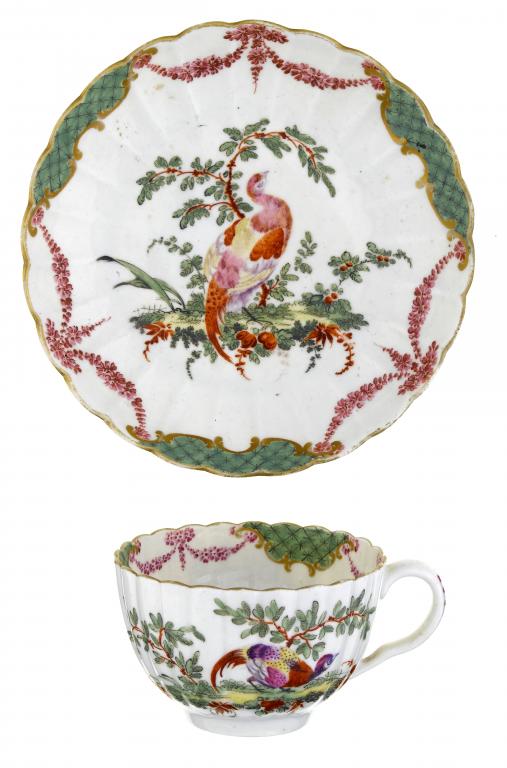 Appraisal: A FIRST PERIOD WORCESTER FLUTED TEA CUP AND SAUCER enamelled