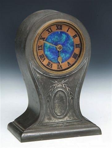 Appraisal: A PEWTER MANTEL CLOCK with enamel dial in the Liberty