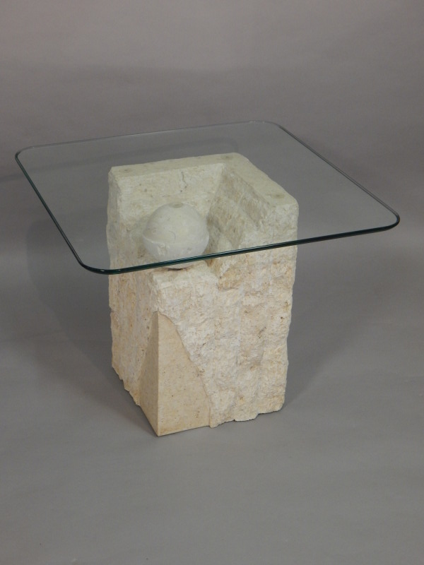 Appraisal: A modern carved stone occasional table with a rectangular glass