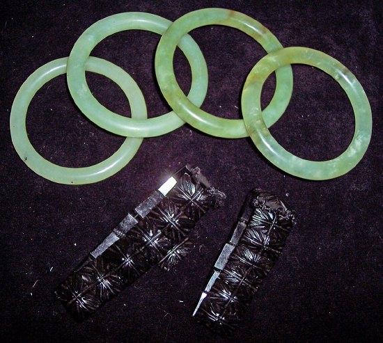 Appraisal: Four nephrite bangles together with two jet bracelets