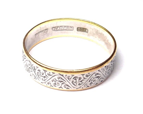 Appraisal: A platinum and gold wedding band ring with scroll engraved