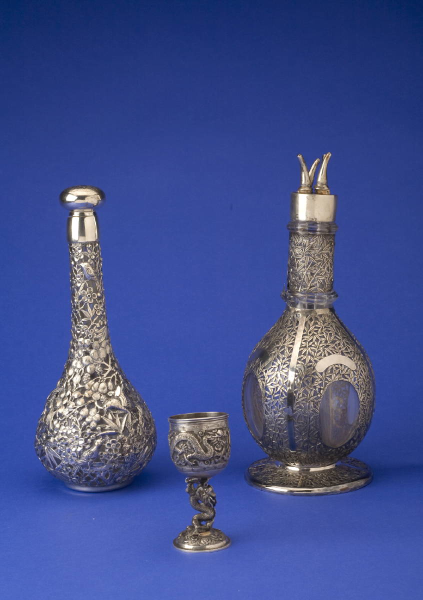 Appraisal: TWO CHINESE EXPORT SILVER-OVERLAY GLASS DECANTERS AND STOPPERS WANG HING