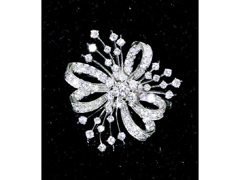 Appraisal: DIAMOND BROOCH White gold with ribbon spray design set with