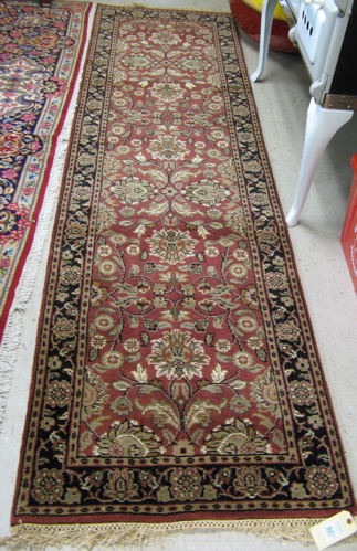 Appraisal: HAND KNOTTED ORIENTAL HALL CARPET Indo-Persian floral design on madder