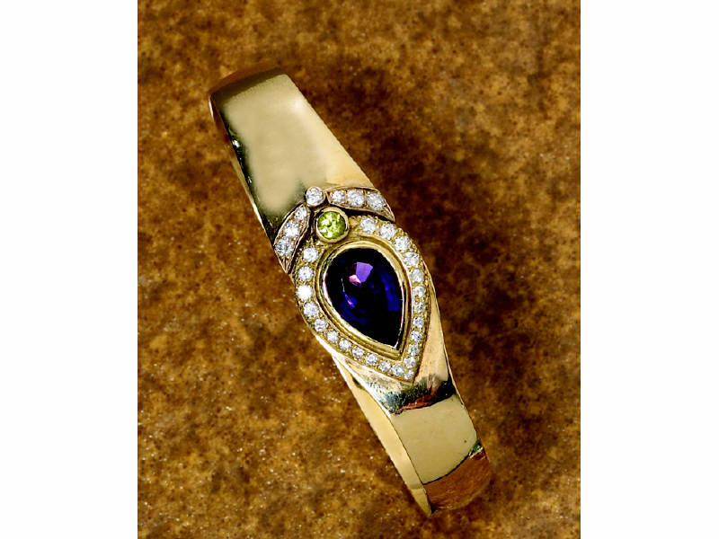 Appraisal: AMETHYST AND DIAMOND BANGLE With pear shaped faceted amethyst approximately