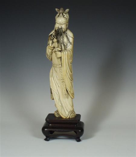 Appraisal: A Japanese ivory figure of a man with a sword