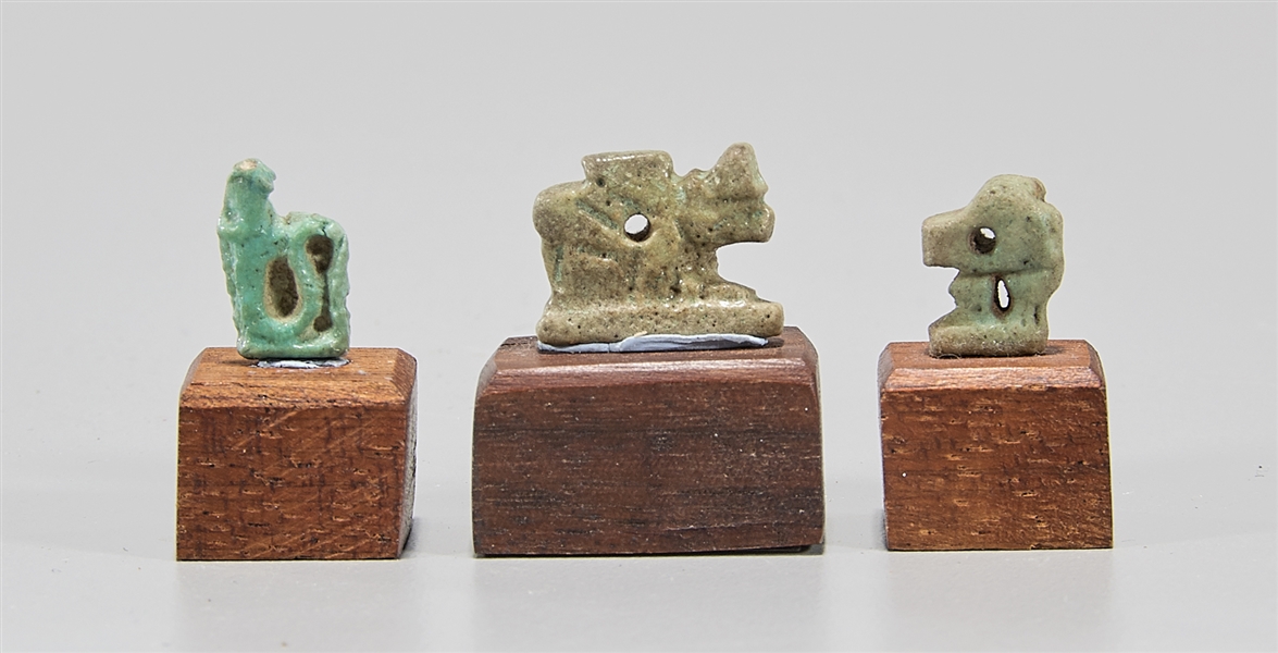 Appraisal: Group of Egyptian faience amulets on wooden bases c Late