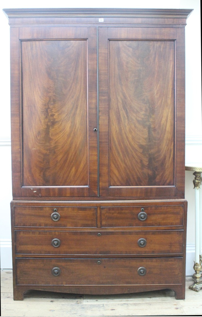 Appraisal: A George III mahogany linen press enclosed by a pair