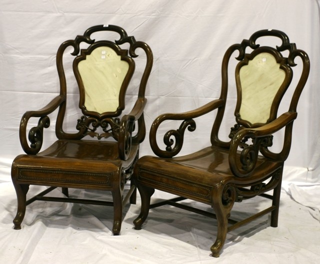 Appraisal: A pair of Chinese carved hardwood hall chairs