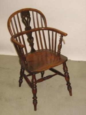 Appraisal: A YEW WINDSOR ARM CHAIR of low double hoop form