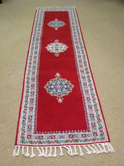 Appraisal: Moroccan red wool runner carpet with white and light blue