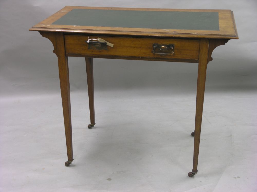 Appraisal: An Edwardian walnut writing table inset vinyl top above single