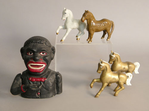 Appraisal: Four cast iron horse toys together with a reproduction Jolly