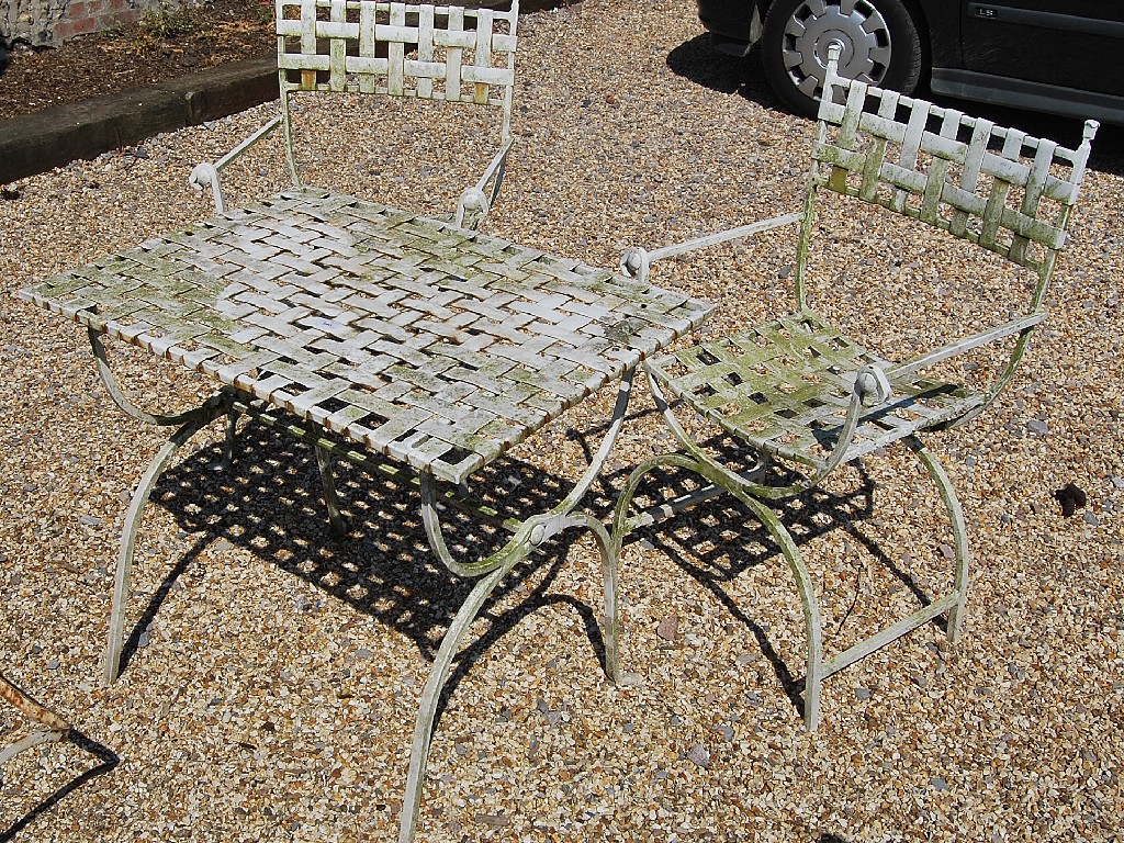 Appraisal: Painted woven metal terrace table and two chairs