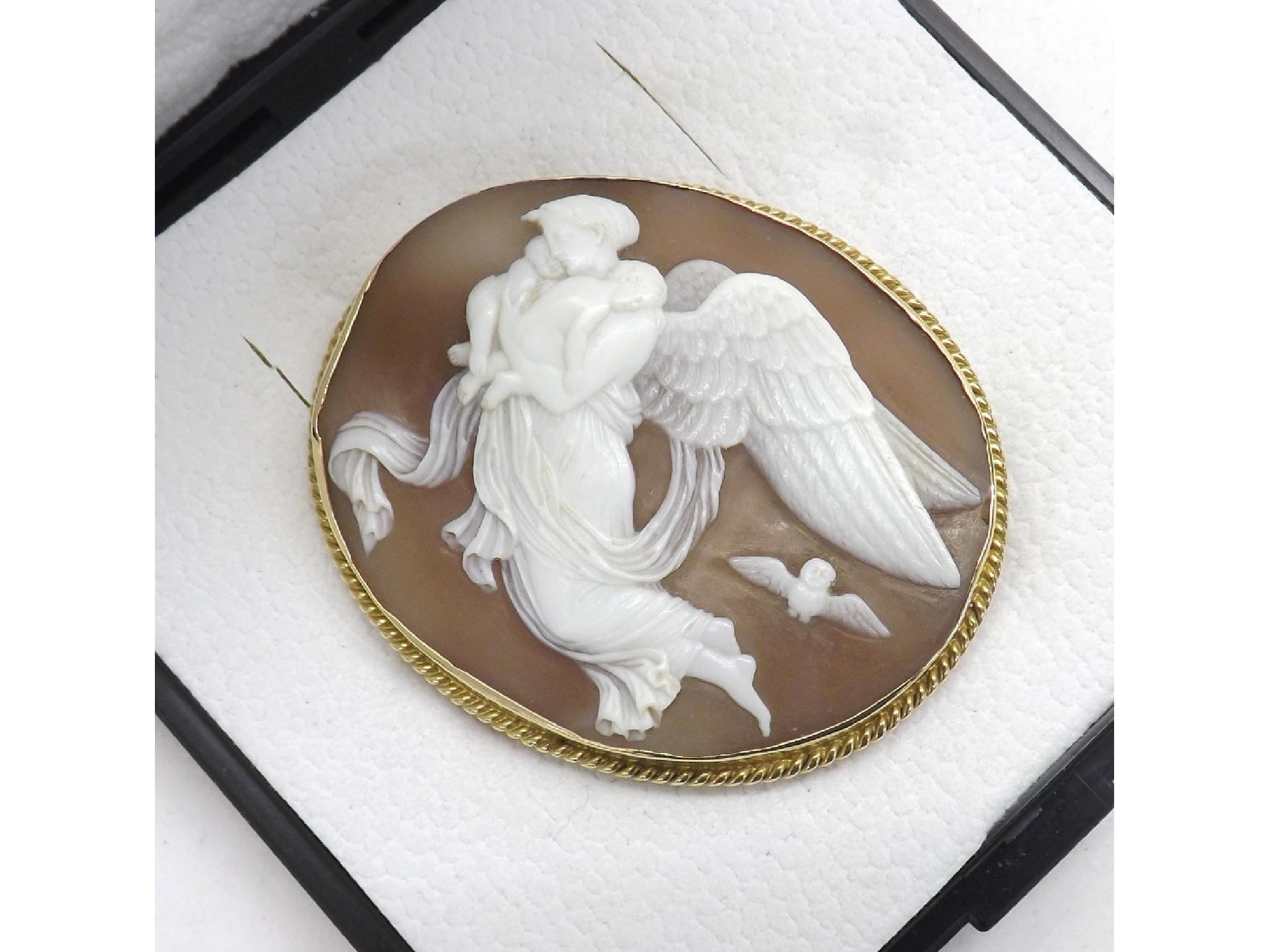 Appraisal: Gold mounted cameo brooch carved with an angel carrying two