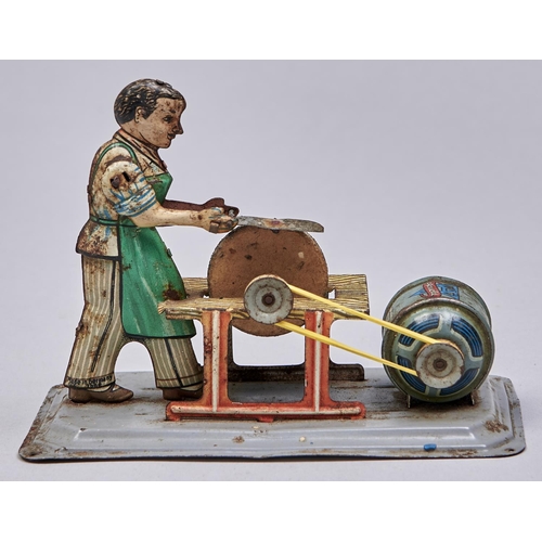 Appraisal: An Arnold lithographed tinplate clockwork figural knife sharpener toy More