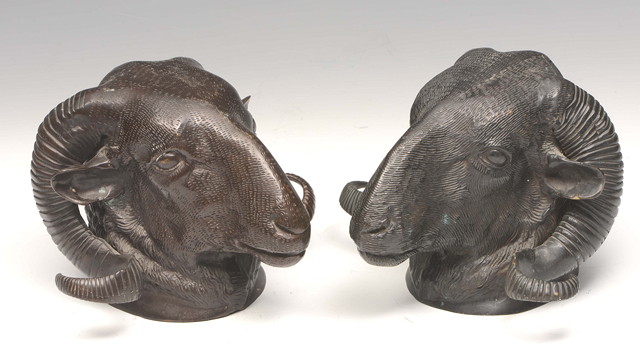 Appraisal: A PAIR OF BRONZE RAMS HEADS AFTER THE ANTIQUE with