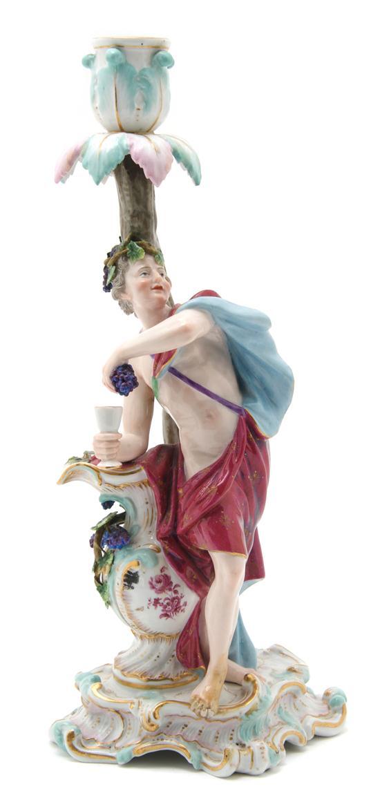 Appraisal: A Meissen Porcelain Figural Candlestick depicting a Bacchic character with