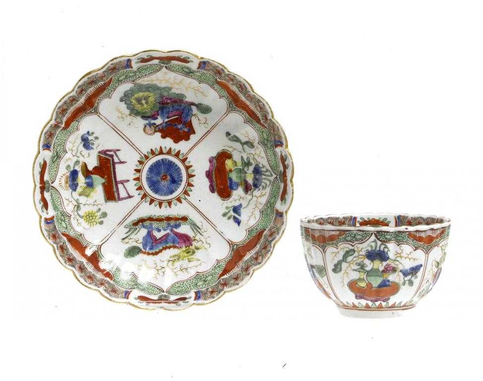 Appraisal: A WORCESTER FLUTED TEA BOWL AND SAUCER enamelled with the