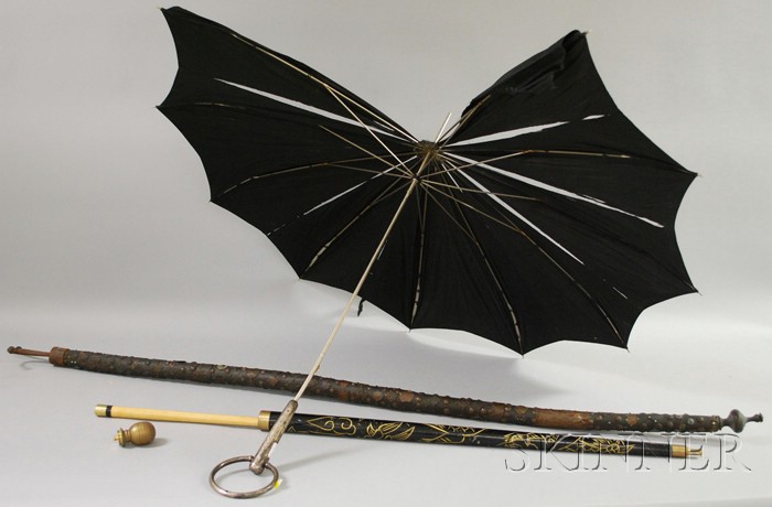 Appraisal: Three Miscellaneous Items a silver-handled umbrella Asian brass-mounted carved wooden