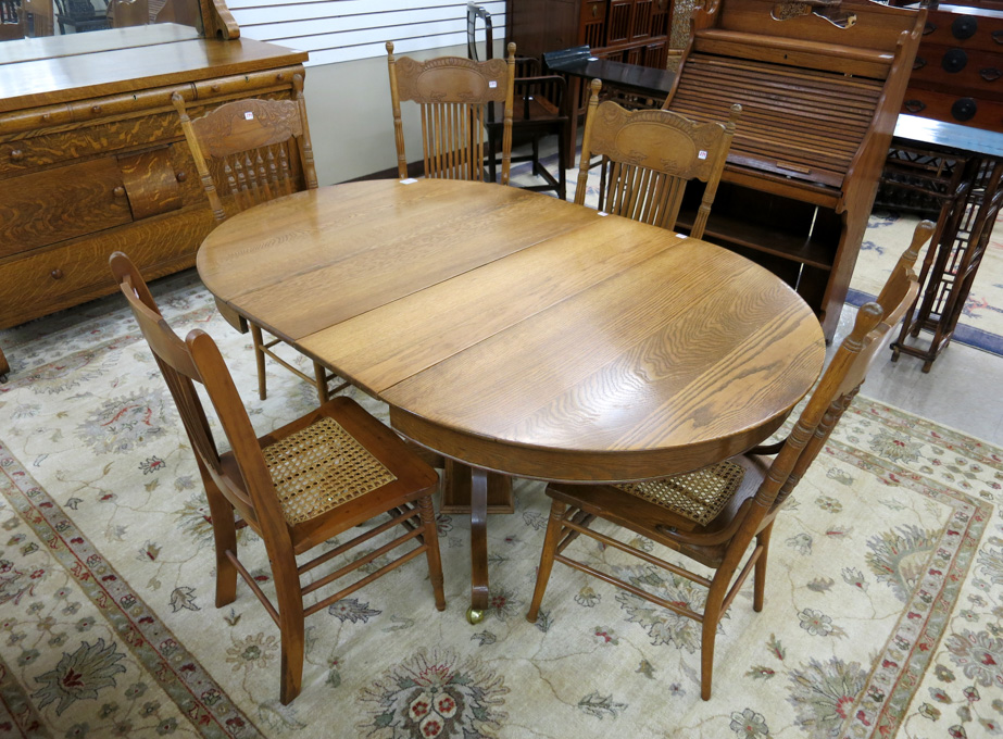 Appraisal: ROUND OAK DINING TABLE FIVE CHAIRS AND TWO LEAVES American