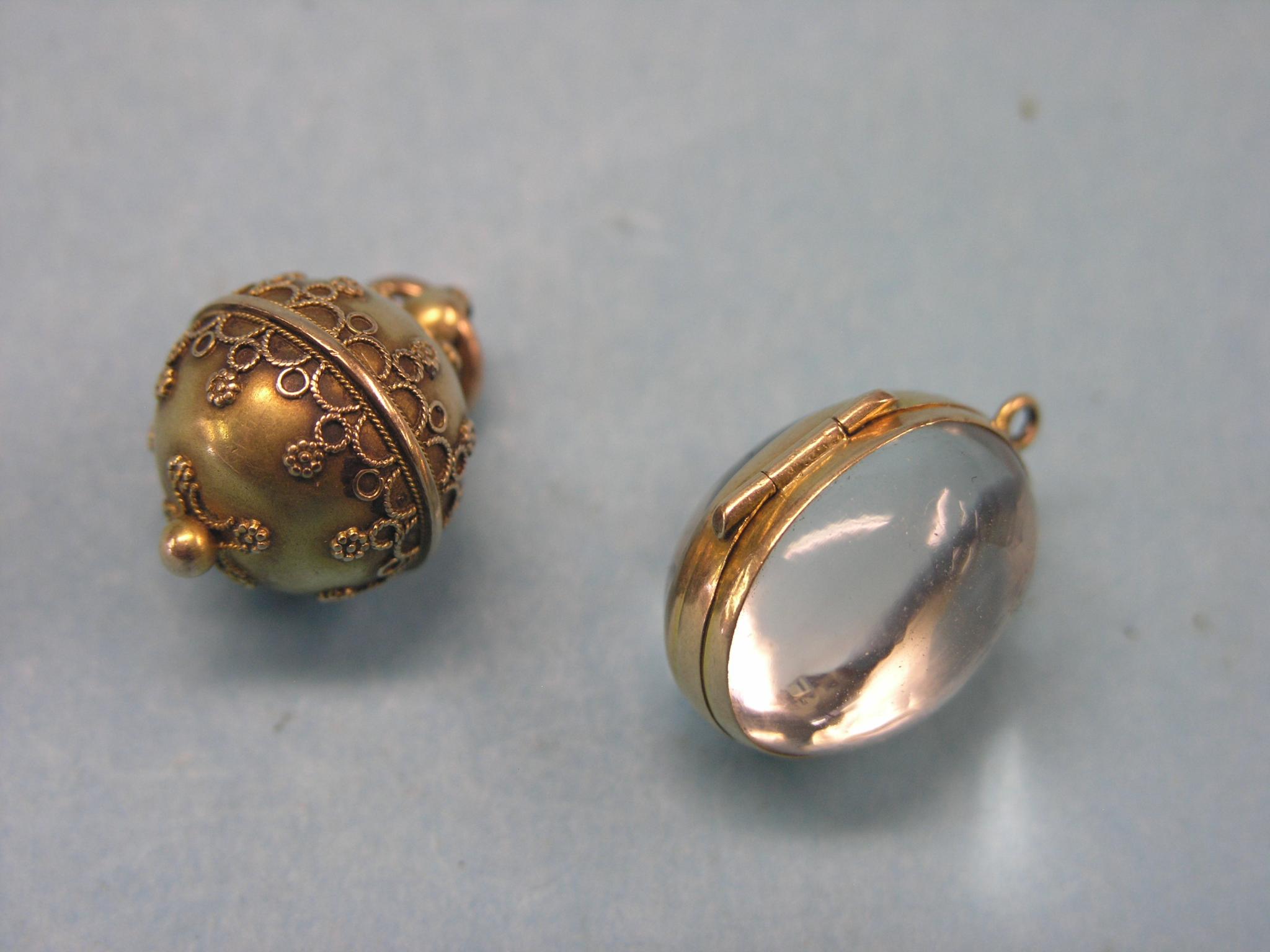 Appraisal: Two yellow metal pendants one globular with filigree the other