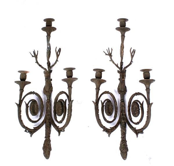 Appraisal: A pair of patinated bronze three light sconces with figural