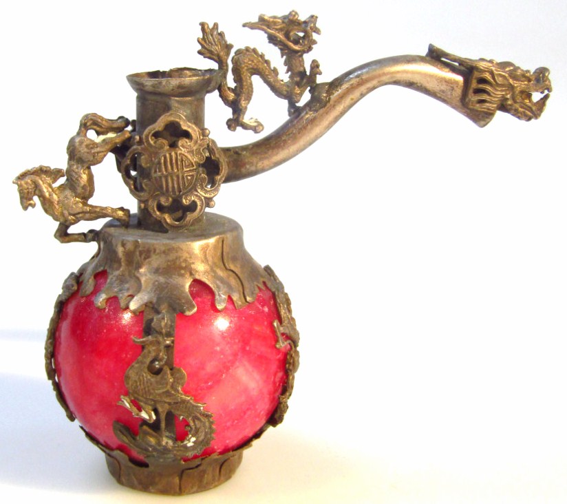 Appraisal: A thC Chinese opium pipe head heavily decorated and cast