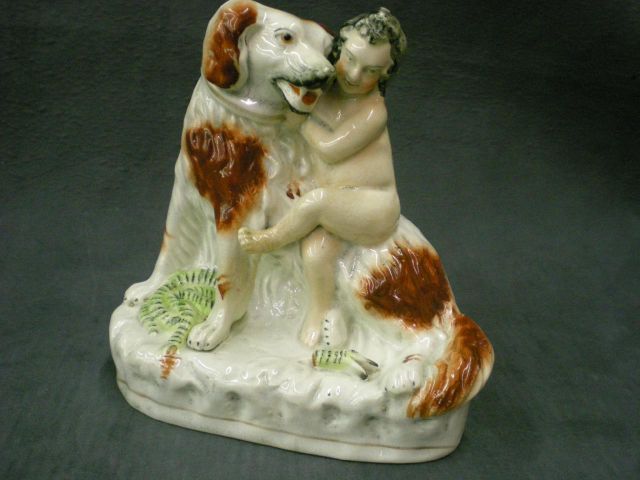 Appraisal: Staffordshire figure depicting black and white dog saving a child