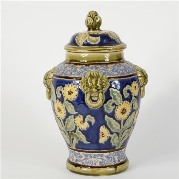 Appraisal: Continental faience lidded urn with lion-head mounts and sunflower design