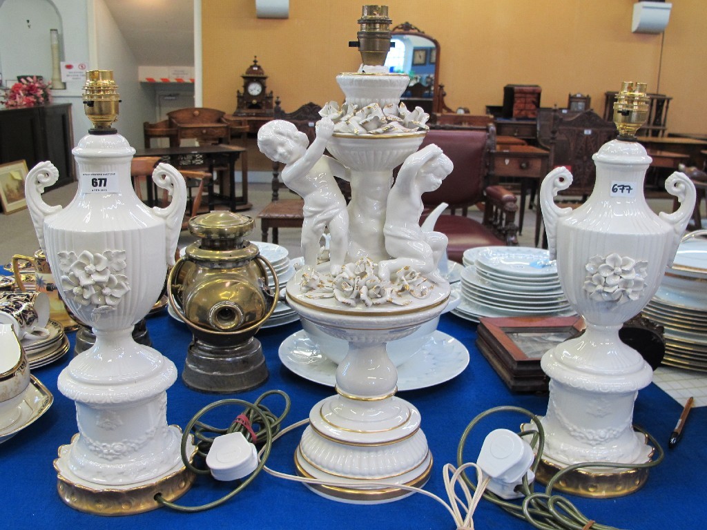 Appraisal: Italian garniture of three table lamps the centre with cherubs