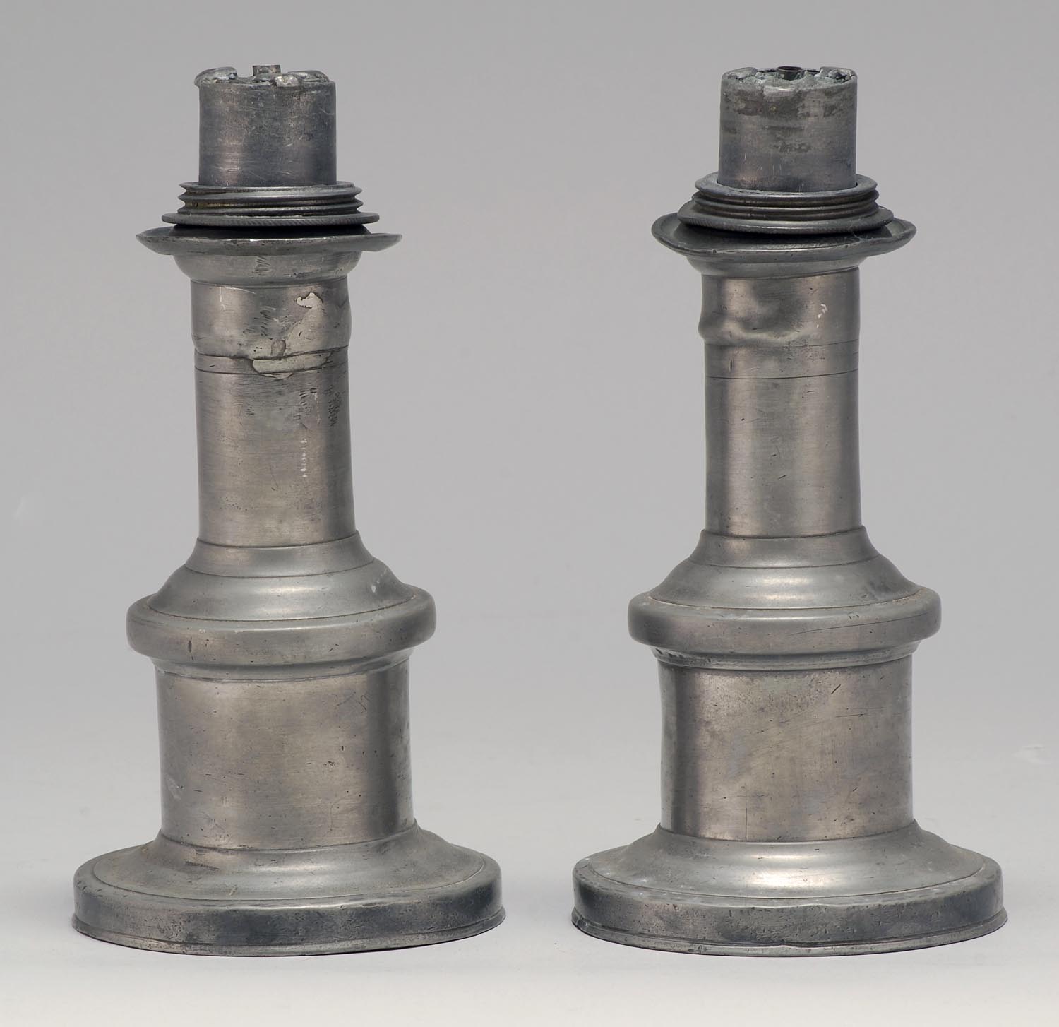 Appraisal: PAIR OF EARLY TH CENTURY PEWTER LIGHTING DEVICES Origin unknown