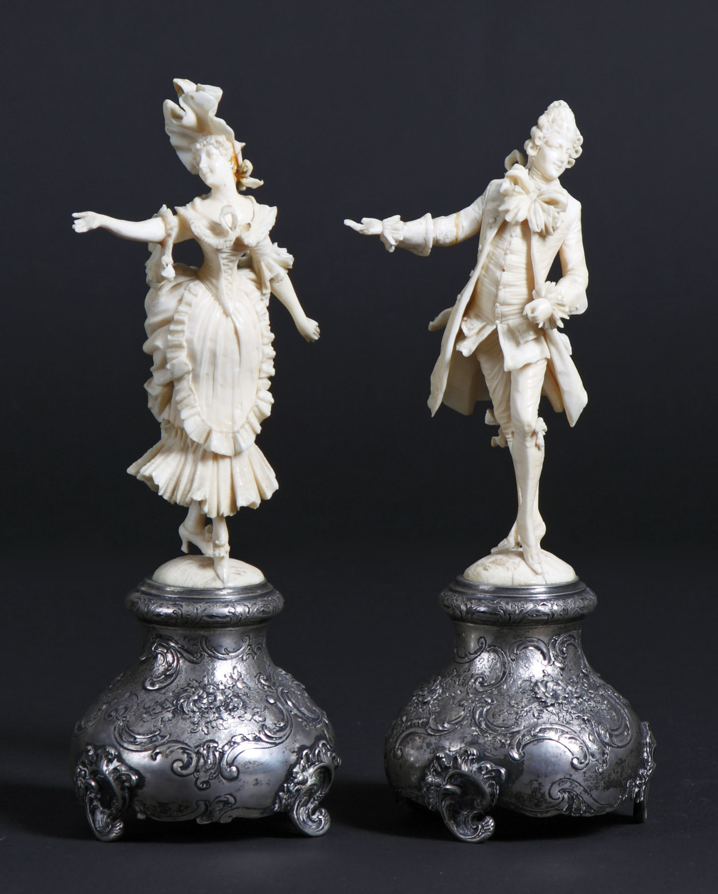 Appraisal: Carved Ivory Figures of Man Woman on Silver Base Woman