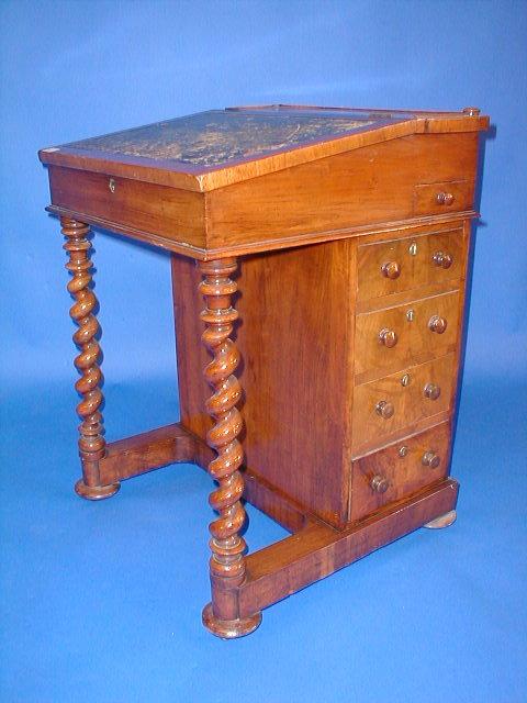 Appraisal: A Victorian walnut Davenport with barley twist columns