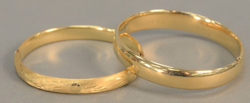 Appraisal: Two K gold bangle bracelets gr Two K gold bangle