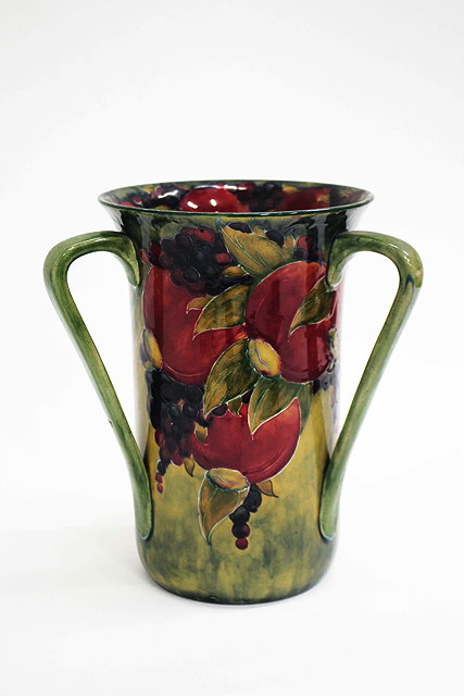 Appraisal: AN EARLY TH CENTURY WILLIAM MOORCROFT POMEGRANATE PATTERN THREE HANDLED