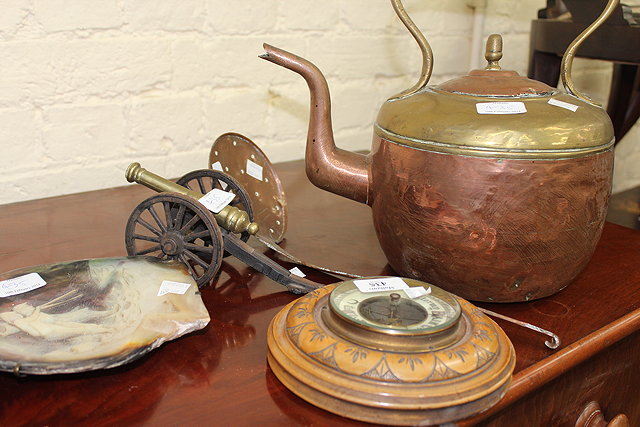 Appraisal: A CIRCULAR ANEROID BAROMETER a kettle a skimmer and a