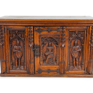 Appraisal: A Renaissance Revival Carved Oak Trunk with Iron Mounts TH