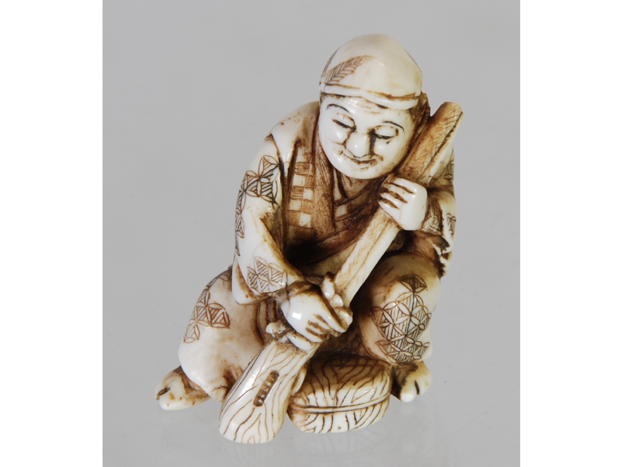 Appraisal: AN ORIENTAL CARVED NETSUKE in the form of an old