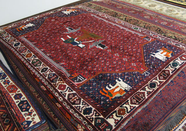 Appraisal: PERSIAN SHIRAZ CARPET the red field centering a pictorial medallion