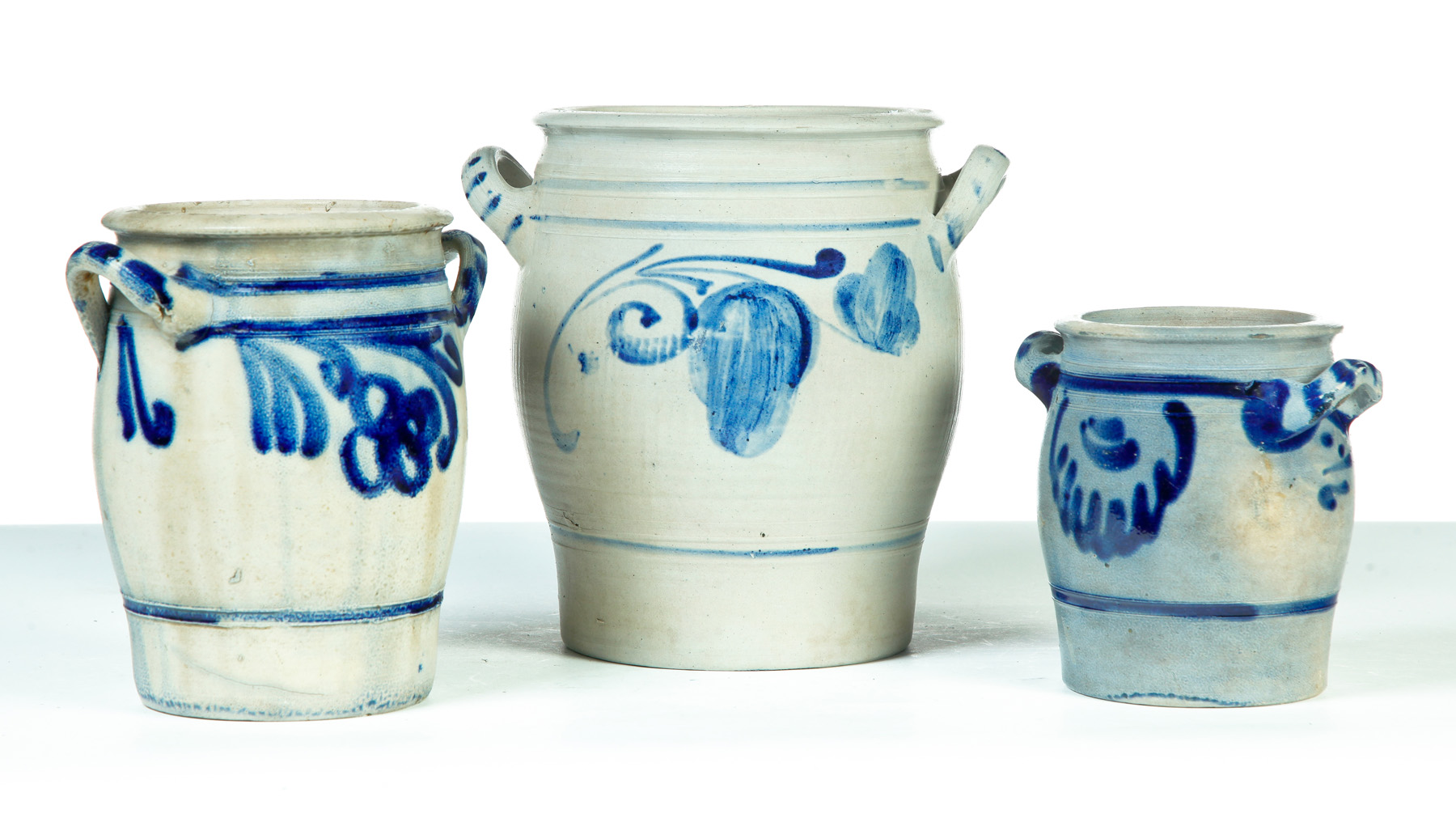 Appraisal: THREE GERMAN GRADUATED DOUBLE-HANDLED STONEWARE JARS Nineteenth century Salt glaze