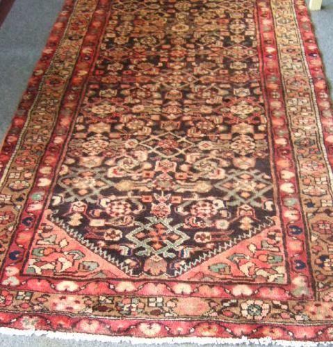 Appraisal: A Hamaden long rug the bark brown field with an