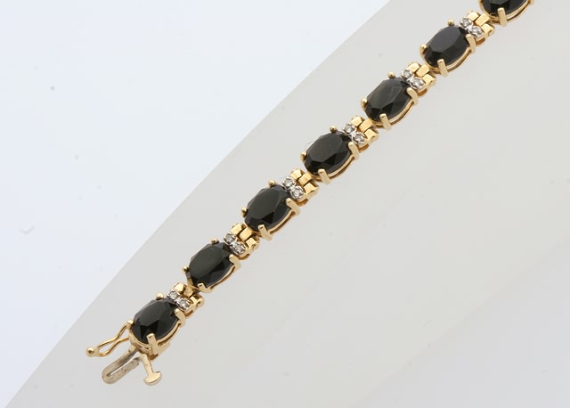 Appraisal: KY long X mm faceted black onyx ovals and round