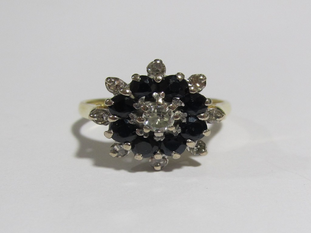 Appraisal: An eighteen carat gold sapphire and diamond flower head cluster