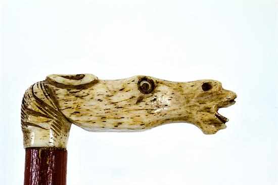 Appraisal: Figural carved bone riding crop early th century horse-head end