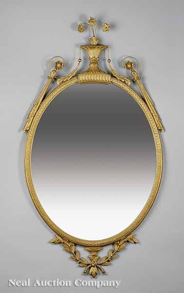 Appraisal: An Adam-Style Giltwood Mirror the molded oval frame with urn