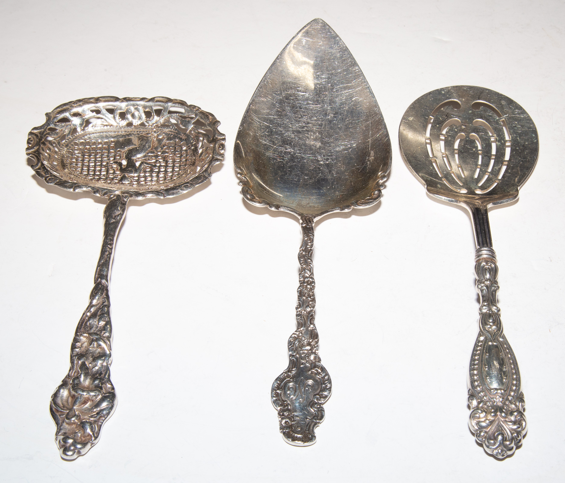 Appraisal: THREE STERLING SILVER SERVING PIECES Including a Lily pierced spoon