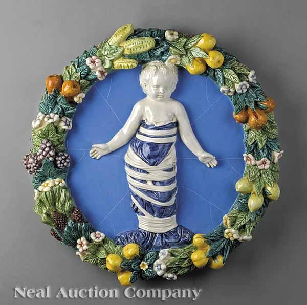 Appraisal: An Italian Majolica Della Robbia Plaque central putti on blue