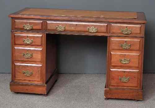 Appraisal: A late Victorian walnut kneehole desk the top with replacement