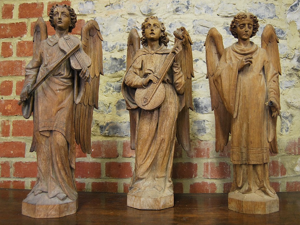 Appraisal: Three carved wood angels each cm tall circa